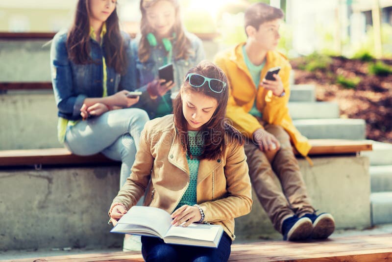 High school student girl reading book outdoors stock images High school student girl reading book outdoors stock images