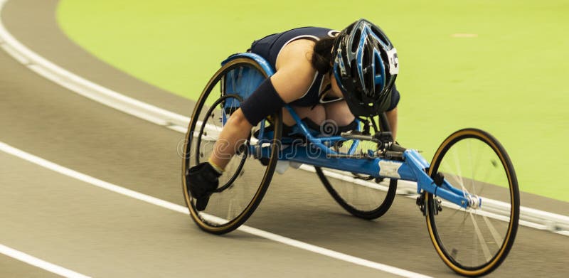 Wheelchair athlete racing the mile indoors stock photography Wheelchair athlete racing the mile indoors stock photography