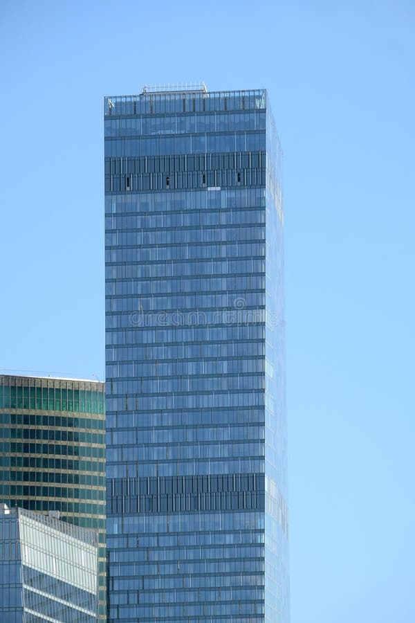 Tower building with panoramic windows in modern city office business center over clear cloudless blue sky vertical view royalty free stock image Tower building with panoramic windows in modern city office business center over clear cloudless blue sky vertical view royalty free stock image