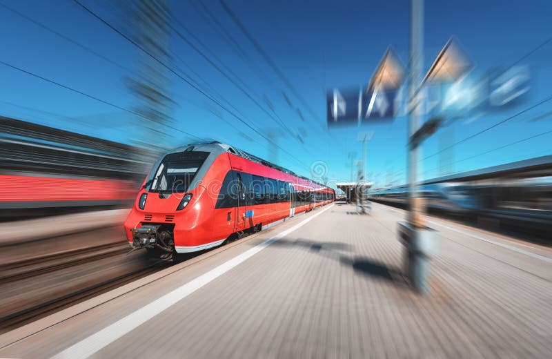 High speed red train in motion on the railway station