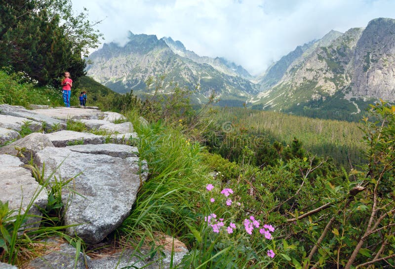 High Tatras (Slovakia) summer view and family on footway.