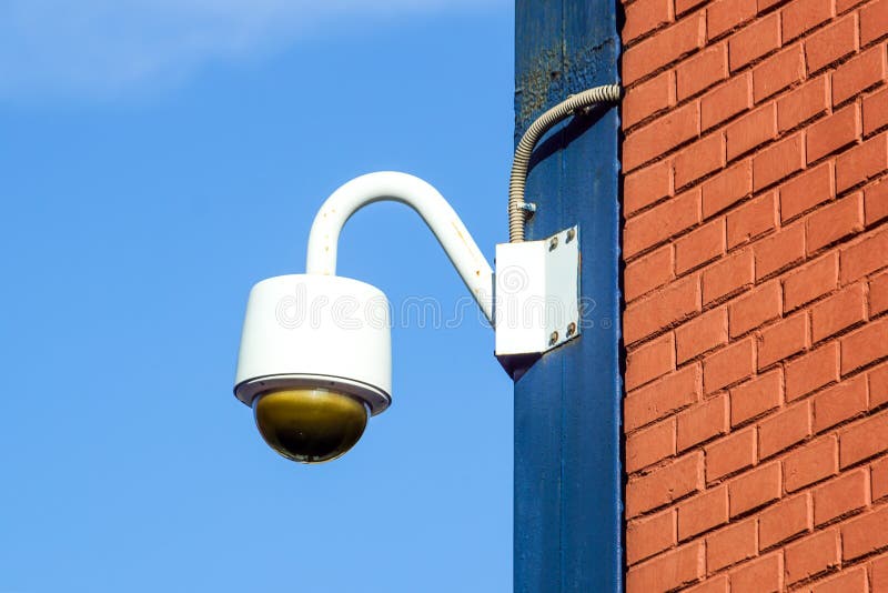 High Tech Overhead Security Camera with Dark Thunderstorm Sky. Stock