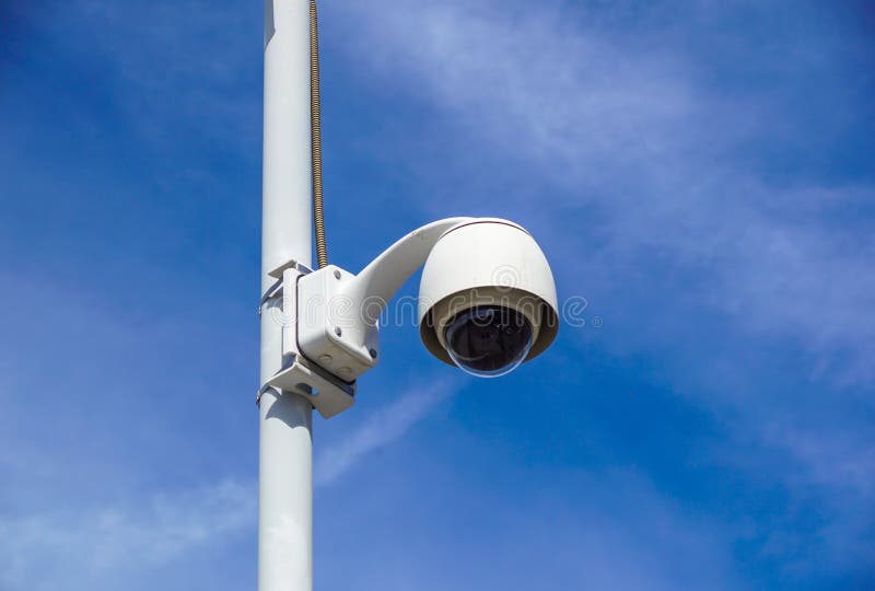 High Tech Overhead Security Camera with a Gradient Blue Sky. Stock