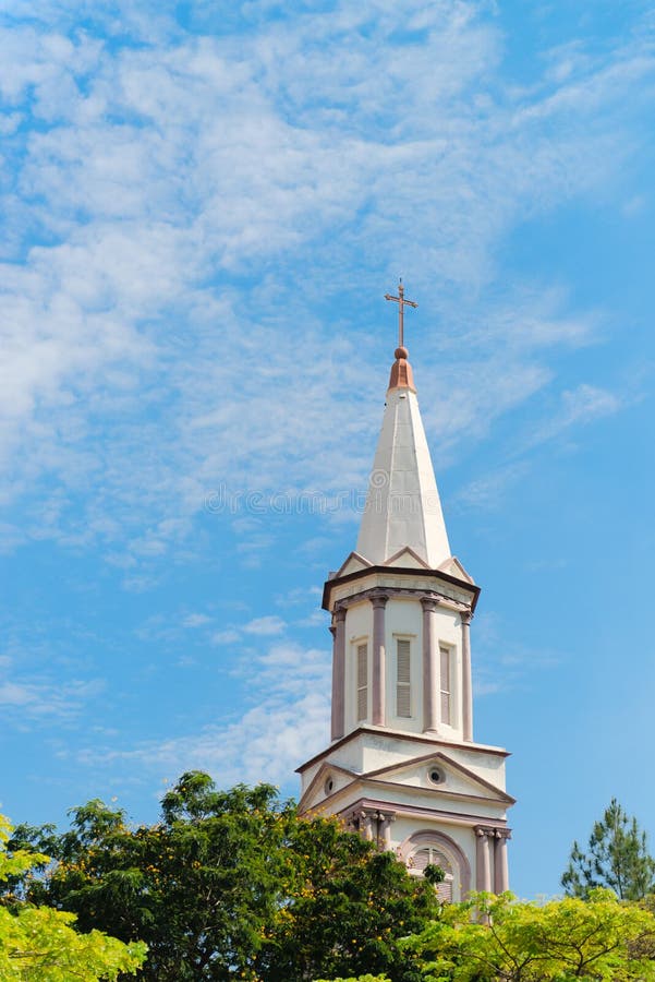 High tower turret of the church under blue sky