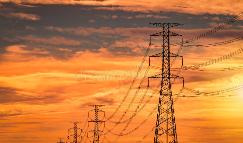 High voltage electric pole and transmission line in the evening. Electricity pylons at sunset. Power and energy. High voltage grid