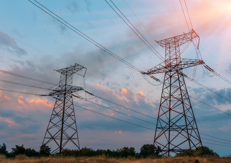 High voltage electric power steel tower in the setting sun, closeup of photo