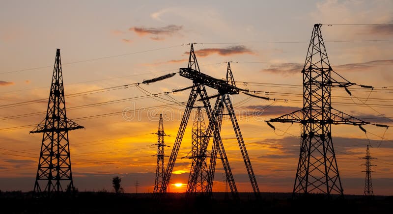 High voltage electricity pylon over sunset