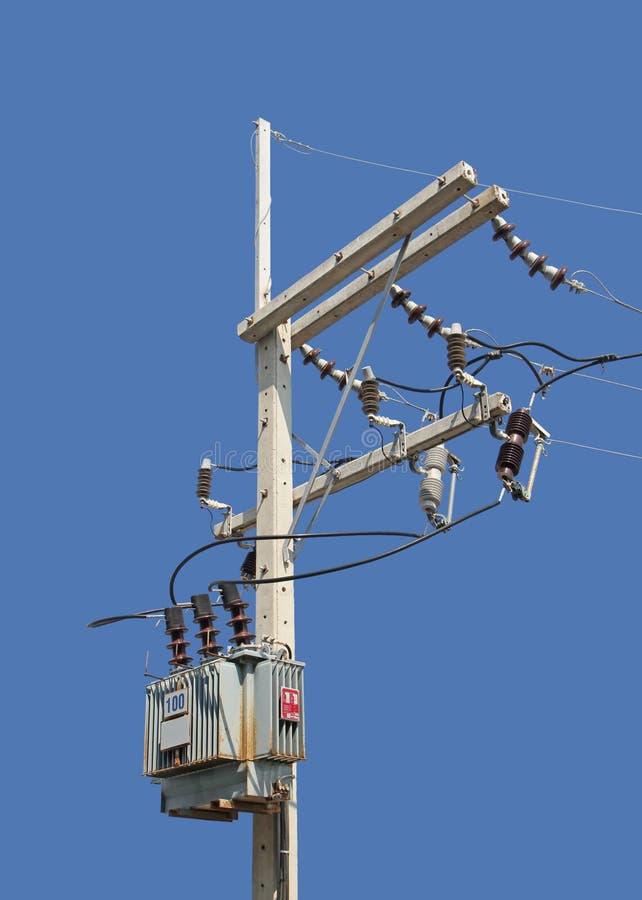 High Voltage Pole with Transformer isolated on Blue Background royalty free stock photo
