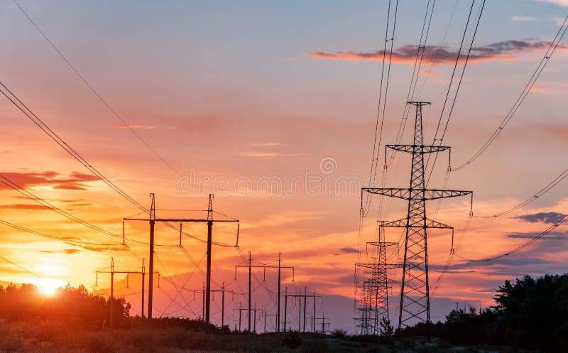 High-voltage power lines at sunset. electricity distribution station. high voltage electric transmission tower.