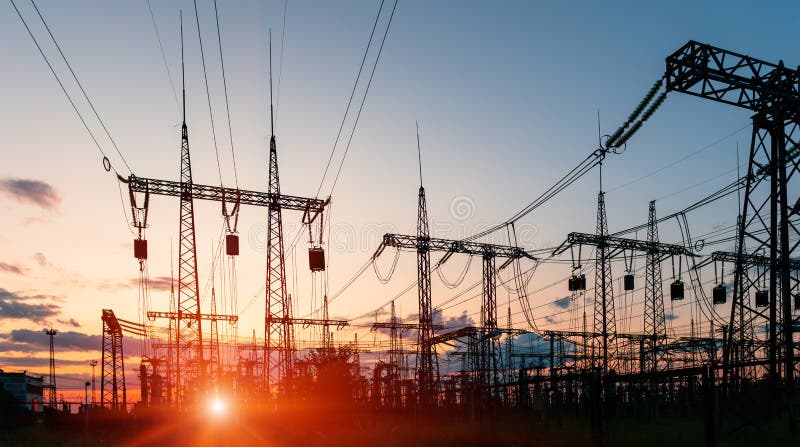 High-voltage power lines at sunset or sunrise. High voltage electric transmission tower