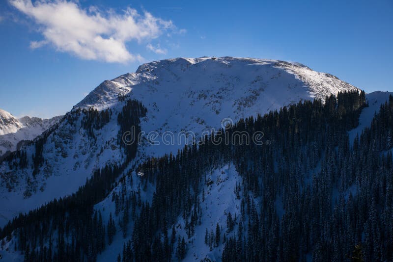 In Taos New Mexico with Snow covering the ground. This Valley Red River MountainScape this is a gorgeous valley in northern New mexico this river runs along some of the most natural lands in all of America. Kachina peak is a huge amazing steep back country mountain with americas newest highest lift to take skiers and snowboarders to a new high The city of Toas after it snowed looking down the ally. In Taos New Mexico with Snow covering the ground. This Valley Red River MountainScape this is a gorgeous valley in northern New mexico this river runs along some of the most natural lands in all of America. Kachina peak is a huge amazing steep back country mountain with americas newest highest lift to take skiers and snowboarders to a new high The city of Toas after it snowed looking down the ally