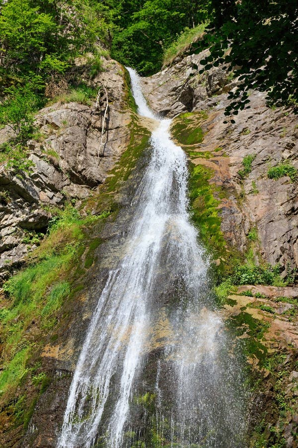 Highest waterfall in national park Mala Fatra, Slovakia. Stream of cold crystal clear water flowing on rocky wall.