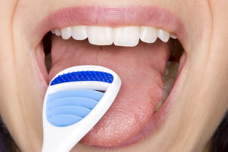 Perfect oral hygiene by cleaning the tongue with a tongue cleaner. Perfect oral hygiene by cleaning the tongue with a tongue cleaner