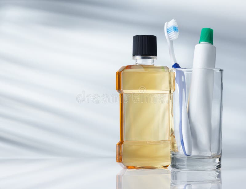 Dental hygiene products on grey background with copy space. Dental hygiene products on grey background with copy space