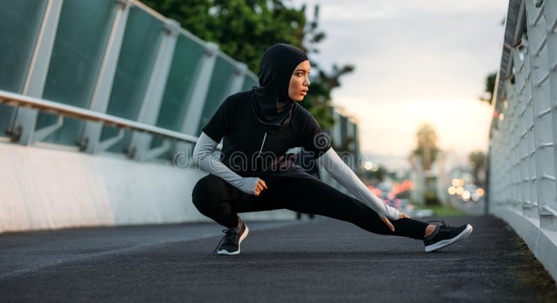 Hijab girl exercising outdoors in early morning