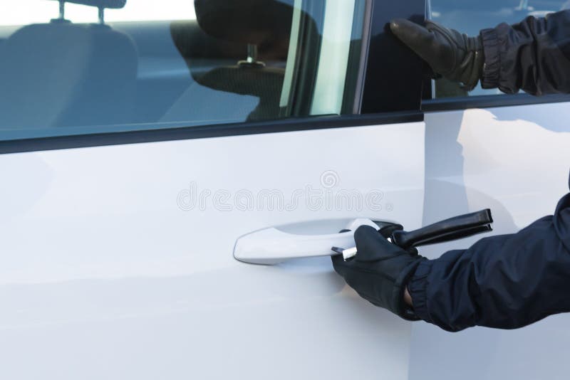 Hijacker Opens a Car Door with a Screwdriver To Steal Stock Photo