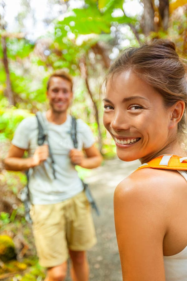 Hike backpackers tourists outdoor travel lifestyle young people walking in forest on trail smiling happy.Two adults couple on royalty free stock images Hike backpackers tourists outdoor travel lifestyle young people walking in forest on trail smiling happy.Two adults couple on royalty free stock images