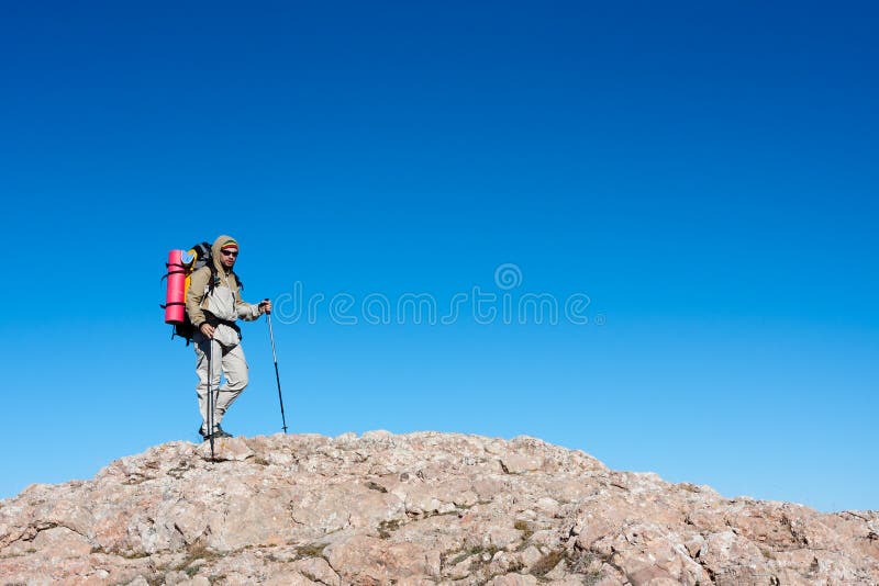 Hiker is climbing mountain stock photos