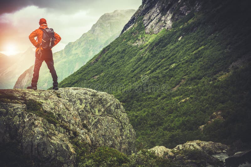 Hiker on the Edge of the World. Caucasian Men Hiking on the Mountain Trail.