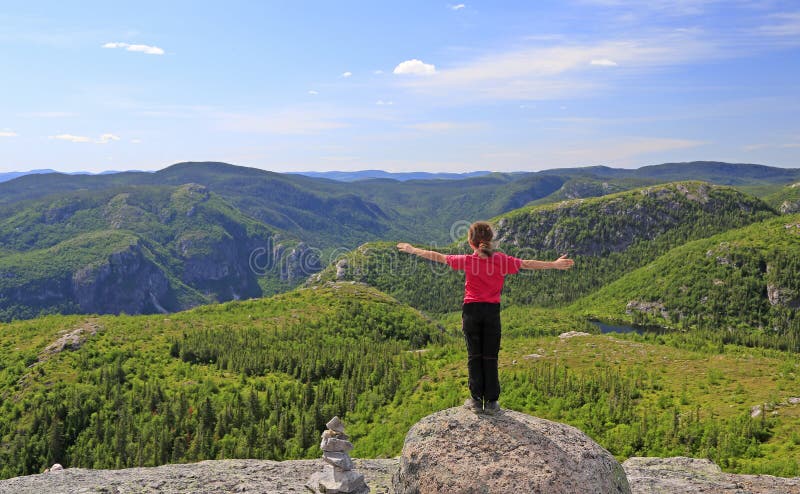 Hiker girl enjoying the scenery on the top of Mont-du-Lac-des-Cygnes in Grand Jardins National Park