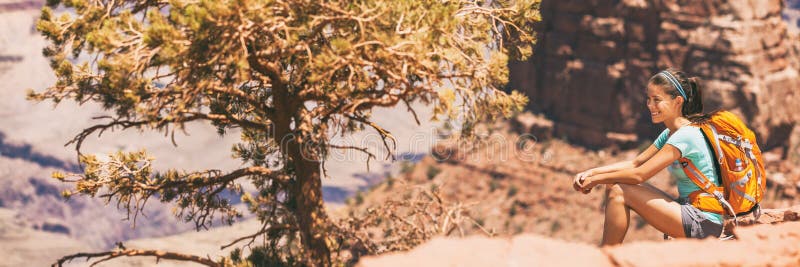 Hiker girl hiking on desert hike trail banner panoramic crop of landscape for copy space. Asian woman resting looking at view of nature with backpack