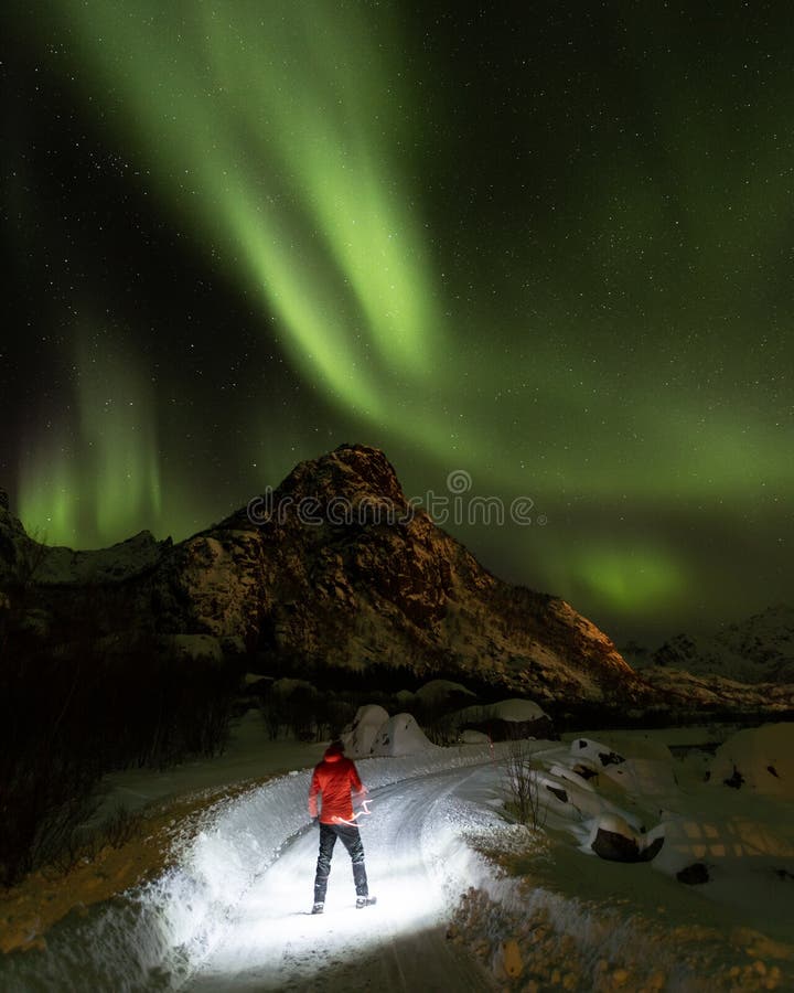 Hiker in the Magical Northern Lights in Lofoten Islands, Norway. Aurora ...