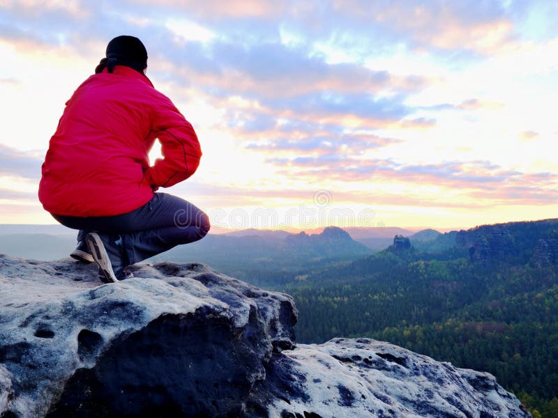 Hiker man take a rest on mountain peak. Man lay on summit, bellow autumn valley. Bright morning Sun royalty free stock photo Hiker man take a rest on mountain peak. Man lay on summit, bellow autumn valley. Bright morning Sun royalty free stock photo