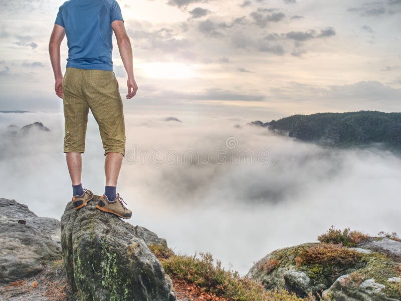 Hiker in middle of nowhere and thinking alone. Man sit on top