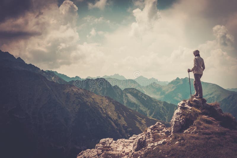 Woman hiker on a top of a mountain. Woman hiker on a top of a mountain