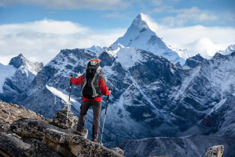 Hiker posing at camera on the trek in Himalayas, Nepal royalty free stock photo
