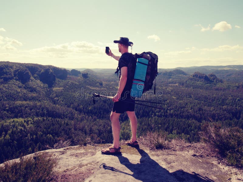 Hiker stay close to edge above forest valley. Travel and hike fashion. Hiker stay close to edge above forest valley. Travel and hike fashion