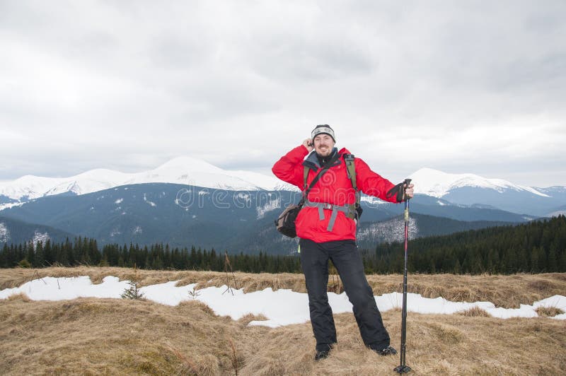 Hiker talking on the smartphone in the winter mountains royalty free stock image Hiker talking on the smartphone in the winter mountains royalty free stock image
