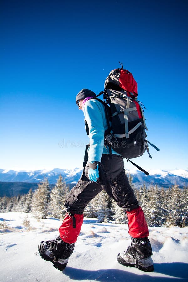 Hiker in winter mountains royalty free stock image