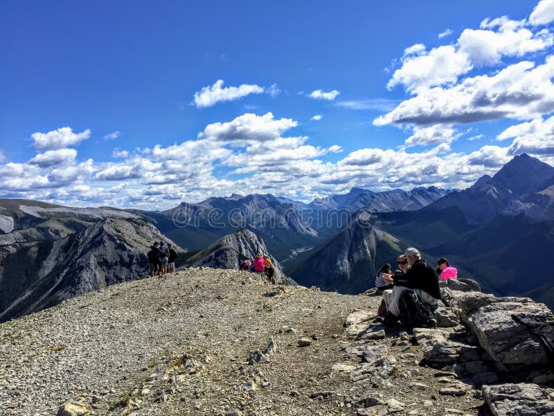Hikers admiring the glorious view of the Rocky Mountains after completing the Sulphur Skyline Trail royalty free stock photos Hikers admiring the glorious view of the Rocky Mountains after completing the Sulphur Skyline Trail royalty free stock photos