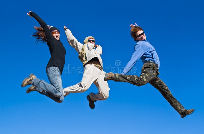 Hikers jumping cheerfully on mountain summit