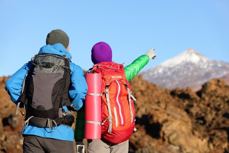 Hikers looking at view pointing hiking in mountain stock photography Hikers looking at view pointing hiking in mountain stock photography