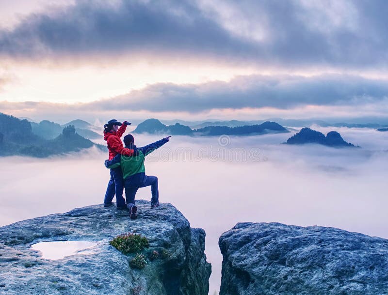 Hikers woman and man  in sportswear on highest mountain