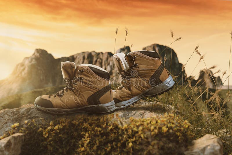 Hiking Boots Walking on Rocks in Front of Mountain Range Stock Photo