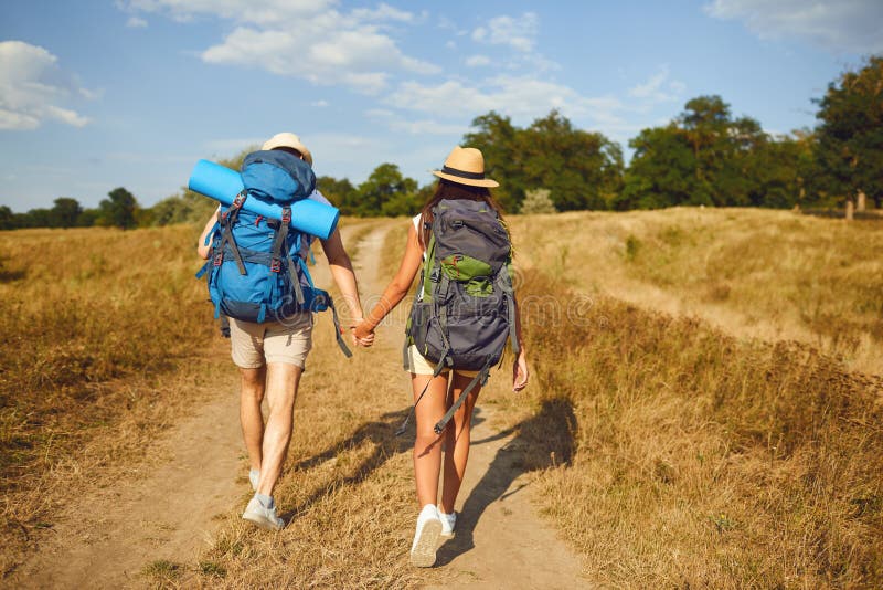 Hiking couple with backpack walking on hike in nature.Backpacker camping traveler trip concept