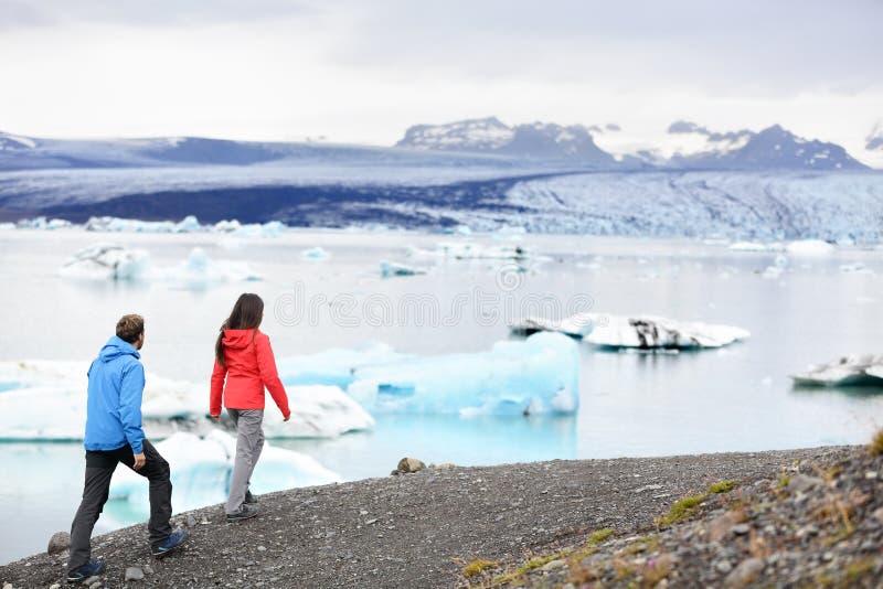 Hiking couple on Iceland Jokulsarlon glacier lake