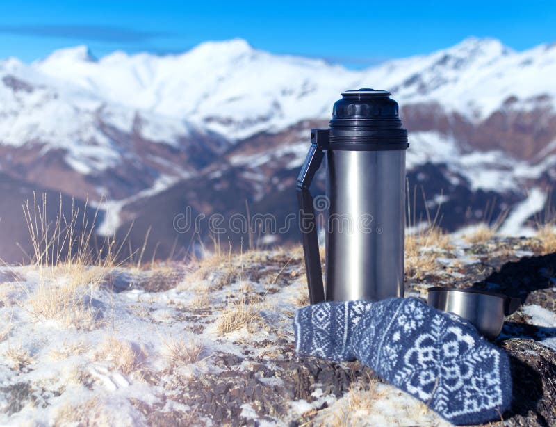 https://thumbs.dreamstime.com/b/hiking-still-life-metal-thermos-top-mountain-background-mittens-snowy-mountains-184378230.jpg