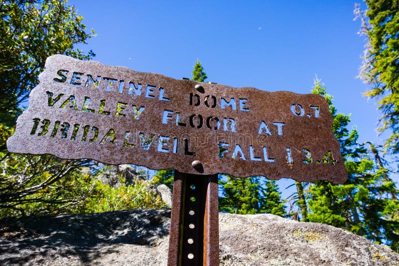 Hiking trail sign posted on the trail to Sentinel Dome, close to Glacier Point, showing points of interest and distances; Yosemite