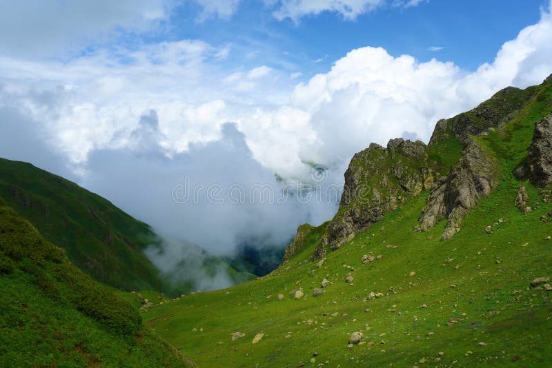 Hiking trail to Silver lakes with clouds around the mountains going via Tobavarchkhili from Mukhuri to Khaishi in Caucasus