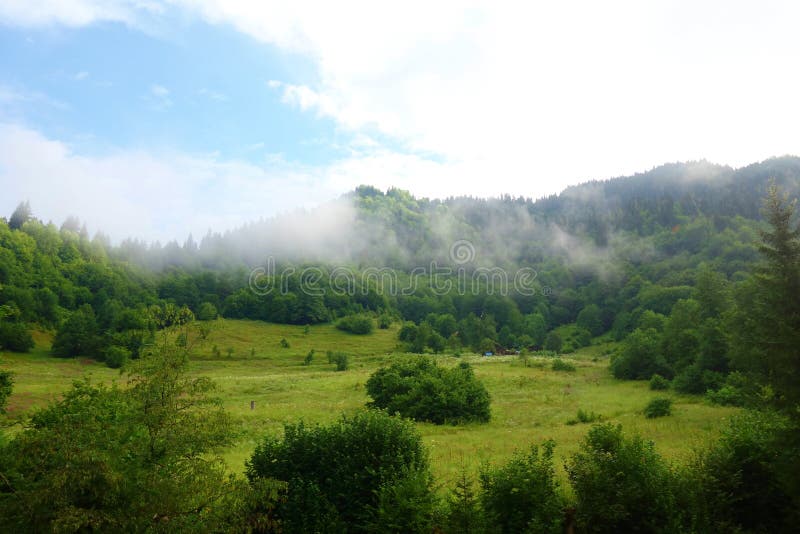 Hiking trail to Silver lakes with clouds around the mountains going via Tobavarchkhili from Mukhuri to Khaishi in Caucasus