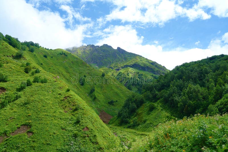 Hiking trail to Silver lakes with clouds around the mountains going via Tobavarchkhili from Mukhuri to Khaishi in Caucasus mountai