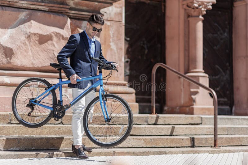 Hilarious smiling male person holding bike