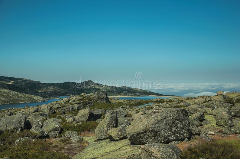 Hilly landscape covered by bushes and rocks on highlands