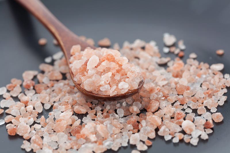 Himalayan pink rock salt in wooden spoon stock images Himalayan pink rock salt in wooden spoon stock images
