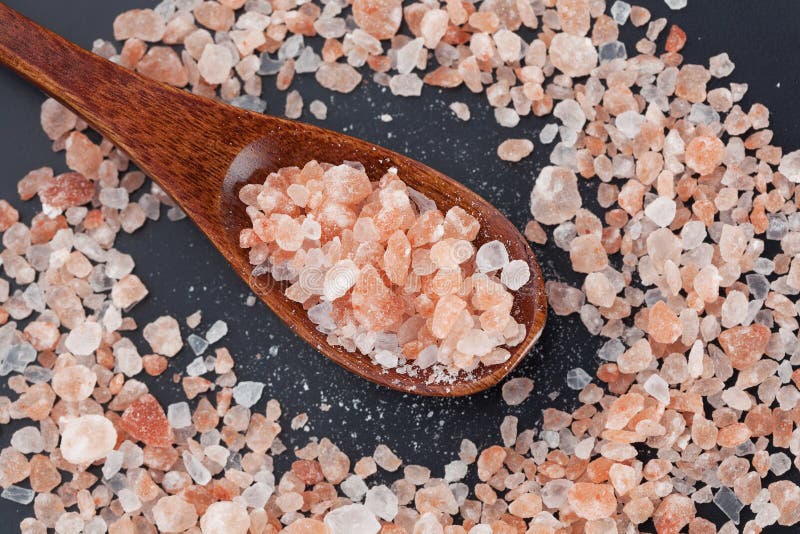 Himalayan pink rock salt in wooden spoon top view royalty free stock photography Himalayan pink rock salt in wooden spoon top view royalty free stock photography