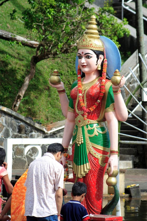 Worshippers praying in front of the statue of a Hindu goddess, Ganga Talao, Mauritius. Worshippers praying in front of the statue of a Hindu goddess, Ganga Talao, Mauritius.